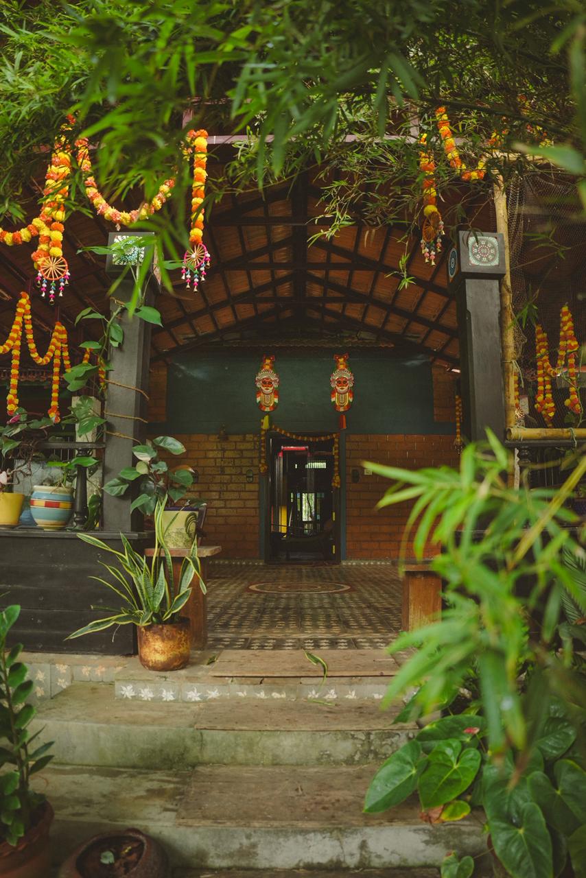 MiliStay entrance decorated with flowers and plants