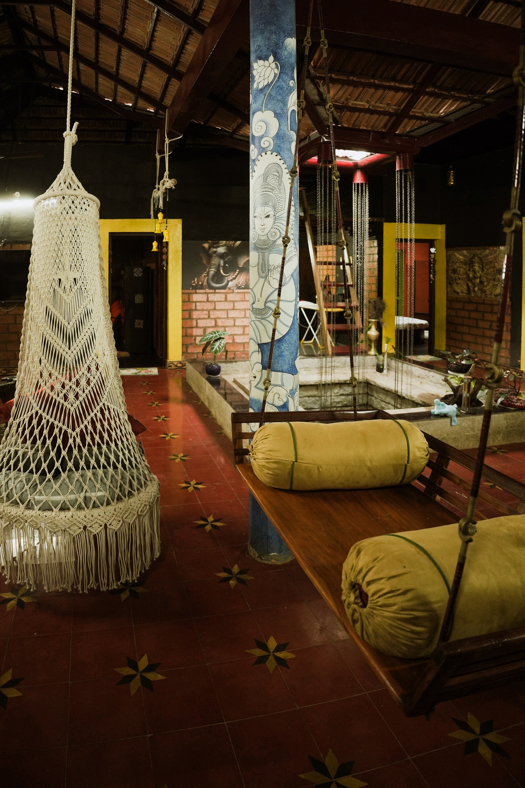 Hanging chairs and hand-painted pillar in the living area