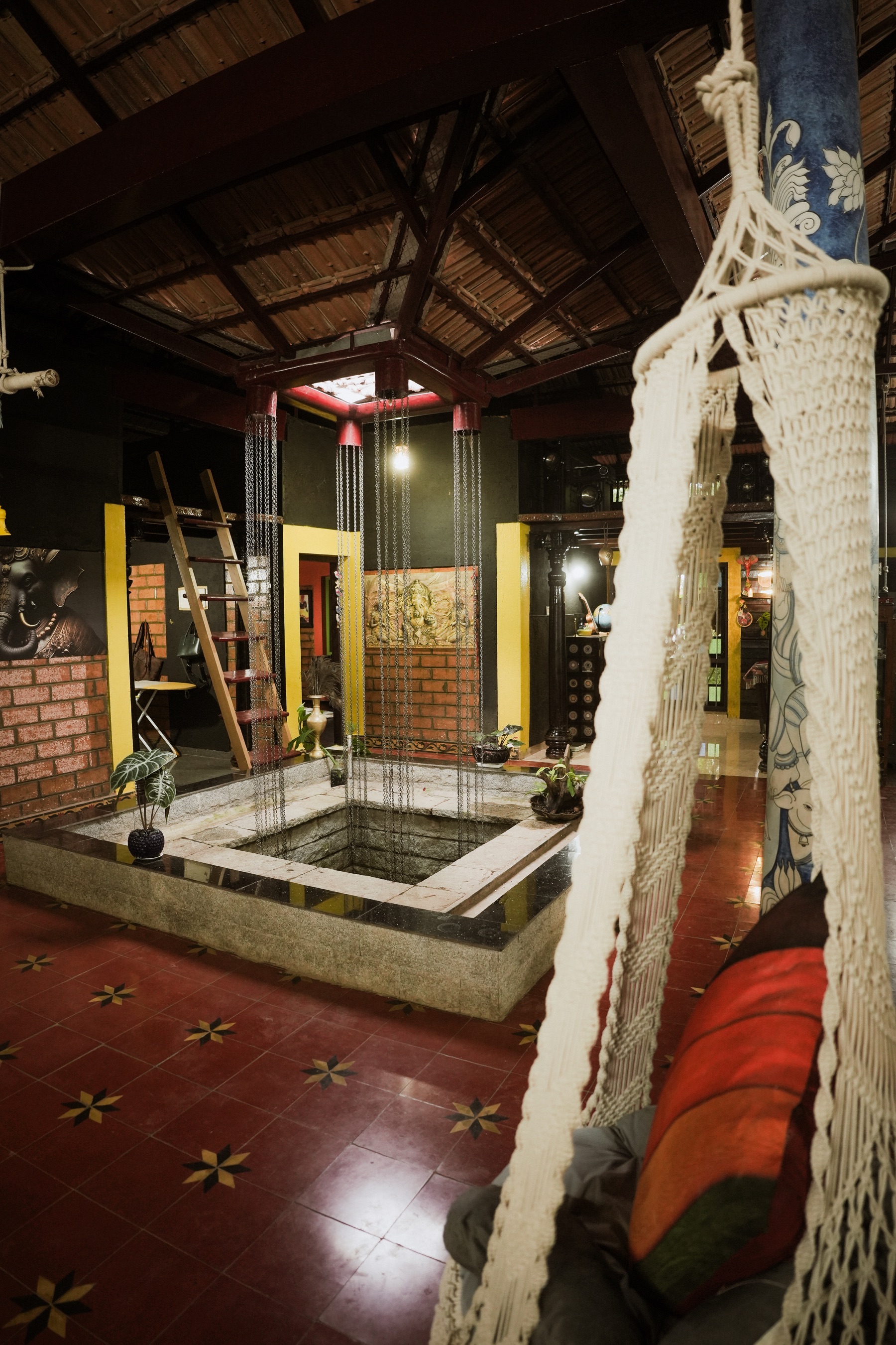 Open courtyard with traditional red flooring and hanging chair